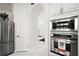 Modern kitchen with stainless steel appliances and white cabinets and marble floors at 2497 Heritage Green Ave, Davenport, FL 33837
