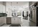 Open kitchen features white cabinetry, stainless steel appliances, and view to the living areas at 2497 Heritage Green Ave, Davenport, FL 33837