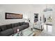 Open-concept living room with view to kitchen, marble floors and comfortable seating at 2497 Heritage Green Ave, Davenport, FL 33837
