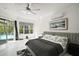 Bright main bedroom features marble floors, ceiling fan, and sliding glass doors leading to a screened pool at 2497 Heritage Green Ave, Davenport, FL 33837