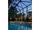 Enclosed pool featuring a mosaic-tiled jacuzzi and a serene outdoor view at 2497 Heritage Green Ave, Davenport, FL 33837