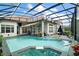 The pool is enclosed by a screened lanai, creating a private and relaxing backyard retreat at 2497 Heritage Green Ave, Davenport, FL 33837