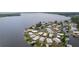 Scenic aerial shot showcasing a community of homes beautifully situated on a lake at 25 Captains Pt, Fruitland Park, FL 34731