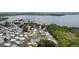 Wide aerial shot showcasing a community of homes nestled along a large lake at 25 Captains Pt, Fruitland Park, FL 34731