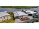Aerial view of a cozy home near a tranquil lake and lush greenery at 25 Captains Pt, Fruitland Park, FL 34731