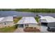 Aerial view of a well maintained home with a carport in a lakeside community at 25 Captains Pt, Fruitland Park, FL 34731
