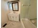 Light-filled bathroom features a new vanity and green tile at 25 Captains Pt, Fruitland Park, FL 34731