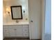 Updated bathroom vanity with framed mirror and sconces at 25 Captains Pt, Fruitland Park, FL 34731