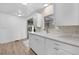 Kitchen features bright white cabinetry and a sliding door to the outside at 25 Captains Pt, Fruitland Park, FL 34731