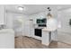 Cozy kitchen features white appliances and cabinetry, open to living spaces at 25 Captains Pt, Fruitland Park, FL 34731