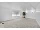 Spacious living room with new carpet, bright lighting, and a large house plant at 25 Captains Pt, Fruitland Park, FL 34731