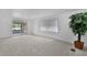 Living room with large glass doors and a house plant at 25 Captains Pt, Fruitland Park, FL 34731