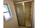 Small shower with sliding glass door at 25 Captains Pt, Fruitland Park, FL 34731