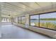 Spacious sunroom featuring large windows with scenic lake views, letting in plenty of natural light at 25 Captains Pt, Fruitland Park, FL 34731