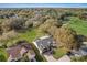 Bird's eye view of a home with a well-manicured lawn, mature trees, and a beautiful landscape at 25273 Lost Oak Cir, Leesburg, FL 34748