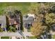 Aerial view of a home showcasing its roof, driveway, and landscaping within the neighborhood at 25273 Lost Oak Cir, Leesburg, FL 34748