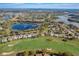 Community aerial view showcasing homes, lakes, mature trees, and a golf course at 25273 Lost Oak Cir, Leesburg, FL 34748