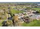 Community aerial view showcasing homes, a golf course, mature trees and a nearby roadway at 25273 Lost Oak Cir, Leesburg, FL 34748