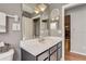 Bathroom vanity featuring a white countertop, large mirror, and neutral gray walls at 25273 Lost Oak Cir, Leesburg, FL 34748