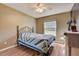 Cozy bedroom with a comfortable bed, a ceiling fan, and soft natural light at 25273 Lost Oak Cir, Leesburg, FL 34748