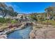 A beautiful building is surrounded by a bridge, waterfall, rocks, and plants at 25273 Lost Oak Cir, Leesburg, FL 34748