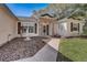 Close-up view of the entrance with brick accents, landscaping, and a decorative water fountain at 25273 Lost Oak Cir, Leesburg, FL 34748