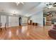 Spacious living room with hardwood floors, high ceilings, and an open layout to the kitchen at 25273 Lost Oak Cir, Leesburg, FL 34748