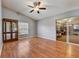Living space boasting hardwood floors, a large window, and sliding door access to another room at 25273 Lost Oak Cir, Leesburg, FL 34748