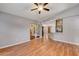 Bright, open-concept living room featuring hardwood floors and a ceiling fan at 25273 Lost Oak Cir, Leesburg, FL 34748