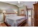 Spacious main bedroom featuring a ceiling fan and en-suite bathroom access at 25273 Lost Oak Cir, Leesburg, FL 34748