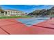 Outdoor tennis court next to clubhouse at 25273 Lost Oak Cir, Leesburg, FL 34748