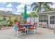 Inviting back patio with seating, an umbrella-covered table, and a cozy swing for outdoor enjoyment at 2529 Cr 448, Lake Panasoffkee, FL 33538