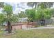 Picturesque backyard deck on the canal with a view of lush trees and charming waterfront properties at 2529 Cr 448, Lake Panasoffkee, FL 33538