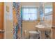 Bathroom with a retro look and color scheme, decorative tile and a matching sink and toilet at 2529 Cr 448, Lake Panasoffkee, FL 33538