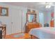 Bright bedroom featuring wood floors, a spacious dresser, and ample storage, providing comfort and functionality at 2529 Cr 448, Lake Panasoffkee, FL 33538
