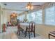 Sunlit dining room features tile flooring, a ceiling fan, and expansive windows with floral valances at 2529 Cr 448, Lake Panasoffkee, FL 33538