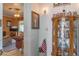 Inviting hallway featuring a display cabinet, art, and view into living area at 2529 Cr 448, Lake Panasoffkee, FL 33538
