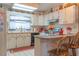 Bright kitchen with classic white cabinets and breakfast bar at 2529 Cr 448, Lake Panasoffkee, FL 33538