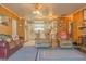 Spacious living room with fireplace, furniture and view into kitchen at 2529 Cr 448, Lake Panasoffkee, FL 33538
