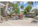 Back patio with an outdoor dining area surrounded by lush greenery and a relaxing swing at 2529 Cr 448, Lake Panasoffkee, FL 33538