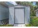Outdoor shed with functional design that is ideal for storage, surrounded by greenery in the backyard at 2529 Cr 448, Lake Panasoffkee, FL 33538
