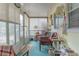 Bright sunroom with lots of windows, offers a tranquil space for relaxation and enjoying the outdoors at 2529 Cr 448, Lake Panasoffkee, FL 33538