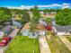 Charming light blue waterfront home featuring a well-manicured lawn, mature trees, and a private dock at 26619 Bimini Dr, Tavares, FL 32778