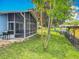 Well-maintained backyard with a screened patio, grill, and access to the lake at 26619 Bimini Dr, Tavares, FL 32778