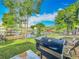 Enjoy the outdoor kitchen with a grill, spacious yard, and waterfront view at 26619 Bimini Dr, Tavares, FL 32778