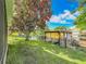 Picturesque backyard leading to the waterfront with boat dock, surrounded by lush landscaping at 26619 Bimini Dr, Tavares, FL 32778