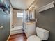 Bathroom featuring tile floors, a shower-tub combo, and granite countertops at 26619 Bimini Dr, Tavares, FL 32778