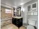 Bathroom with a tub and shower combo and dark wood vanity with a light countertop and neutral tone tile at 26619 Bimini Dr, Tavares, FL 32778