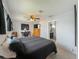 A bedroom featuring carpet, ceiling fan, TV, a window and a full-sized bed at 26619 Bimini Dr, Tavares, FL 32778