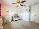 Bright Bedroom with plush carpet, ceiling fan, charming wall decals, and a baby changing station at 26619 Bimini Dr, Tavares, FL 32778